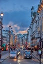 Urban view of London city near Piccadilly Circus with night traffic. Rush hour in London city against a cloudy sky at night Royalty Free Stock Photo