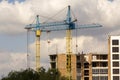 Urban view of silhouettes of two high industrial tower cranes ab Royalty Free Stock Photo