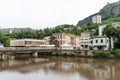 Urban views and decoration of the city Chiatura , Georgia. Blue sky with clouds. River and old houses Royalty Free Stock Photo