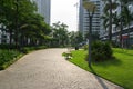 Urban walking road among green tree in modern apartment buildings in big city