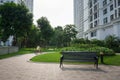 Urban walking road among green tree in modern apartment buildings in big city Royalty Free Stock Photo