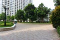 Urban walking road among green tree in modern apartment buildings in big city Royalty Free Stock Photo