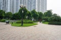 Urban walking road among green tree in modern apartment buildings in big city Royalty Free Stock Photo