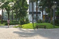 Urban walking road among green tree in modern apartment buildings in big city