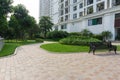 Urban walking road among green tree in modern apartment buildings in big city Royalty Free Stock Photo