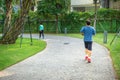 Urban walking road among green trees inside modern apartment building area in big city