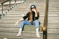 Urban woman with skate. Hipster girl with skateboard in city. Extreme sport and emotions concept. Alternative lifestyle. Stylish Royalty Free Stock Photo