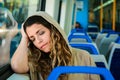 Urban woman sleeping in a train travel beside the window