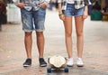 Urband sports. Waist down shot of two people standing with a skateboard. Royalty Free Stock Photo