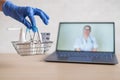 Urchase of medicines using the computer application for home delivery. Pharmacist on laptop screen. A hand in a rubber Royalty Free Stock Photo