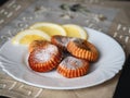 ÃÂ¡urd biscuits and a few slices of lemon in white plate