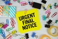 Urgent Final Notice text on stick note with stationery on concrete background Royalty Free Stock Photo