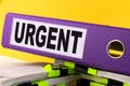 Urgent, Situation Needed, Imperative Important concept. purple folder with the words URGENT Royalty Free Stock Photo