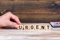 Urgent. Wooden letters on the office desk