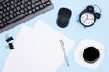 Urgent work, deadline concept. Keyboard with computer mouse, alarm clock, blank paper sheets, stationery, coffee cup on office Royalty Free Stock Photo