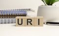 URI - Upper Respiratory Infection word on wooden cubes