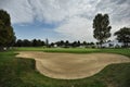 Urin Italy circa September empty golf course green and fairway panoramic view with bunker in foreground Royalty Free Stock Photo