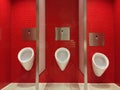 Urinals on the red tiled wall of the bathroom