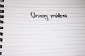 Urinary problems handwriting text on paper, on office agenda. Copy space