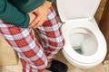 Urination problem, Man in pajamas in the toilet is squeezing his crotch, Health concept, Male prostate problem, Urinary system Royalty Free Stock Photo