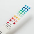 Urine test strip with multiple colored squares, each representing different test parameters such as Royalty Free Stock Photo