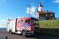 Urk Flevoland Netherlands April 2017, New Dutch red fire truck,fire engine standing in font of the lighthouse with Royalty Free Stock Photo