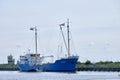 Urk, The Netherlands - June 15, 2020: A large blue and white ship called Paovona. is docked off the coast of Urk, the