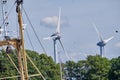 Urk, The Netherlands - June 15 2020 Windmills on the coast with trees, mast and birds moving. Wind power and Green energy. the