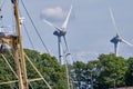 Urk, The Netherlands - June 15 2020: Windmills on the coast with trees, mast and birds moving. Wind power and Green