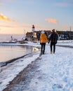 Urk Netherlands lighthouse during winter with snow covered coastline, Urk view at the lighthouse snowy landscape winter Royalty Free Stock Photo