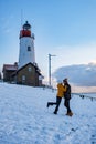Urk Netherlands lighthouse during winter with snow covered coastline, Urk view at the lighthouse snowy landscape winter Royalty Free Stock Photo
