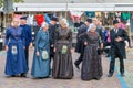 People with traditional clothing and headgear at Dutch local fair