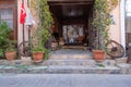 Urla, Izmir, Turkey - 03.08.2021: small hostel and hotel entrance with a historical gate and Turkish flag