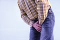 Urolithiasis. Chronic pancreatitis. Stones in the bladder. The man grabbed his groin in a fit of pain Royalty Free Stock Photo