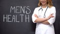 Urologist standing near Mens health words, medical exam to prevent prostatitis