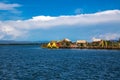 Uros floating island and Totora traditional boat on Titicaca lake, Puno city, Peru Royalty Free Stock Photo