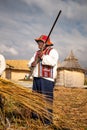 The Uros man showing the tourists the weapon they use to hunt birds