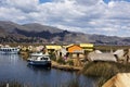 Uros, Peru - Jan 5, 2019. Traditional Totora boat with tourists on Titicaca lake near to the Uros floating islands , Puno, Peru, Royalty Free Stock Photo