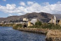 Uros, Peru - Jan 5, 2019. Traditional Totora boat with tourists on Titicaca lake near to the Uros floating islands , Puno, Peru, Royalty Free Stock Photo