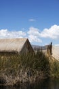 Uros, Peru - Jan 5, 2019. Traditional Totora boat with tourists on Titicaca lake near to the Uros floating islands , Puno, Peru, Royalty Free Stock Photo