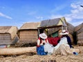 Women uros making tissues on their straw island