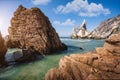 Ursa beach, Sintra, Portugal. Epic seascape of sea stack cliffs towering up from emerald green atlantic ocean. White