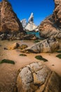 Ursa beach, Sintra, Portugal. Epic seascape with sharp cliffs rising from the turquoise sea waters. Beautiful untouched Royalty Free Stock Photo