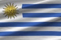 Uruguay flag with big folds waving close up under the studio light indoors. The official symbols and colors in banner