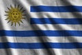 Uruguay flag with big folds waving close up under the studio light indoors. The official symbols and colors in banner