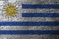 Uruguay flag is depicted on the screen with the program code. The concept of modern technology and site development Royalty Free Stock Photo