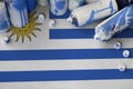 Uruguay flag and few used aerosol spray cans for graffiti painting. Street art culture concept
