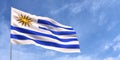 Uruguay flag on flagpole on blue sky background. Uruguayan flag fluttering in the wind against a sky with clouds. Place for text. Royalty Free Stock Photo