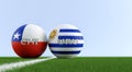 Uruguay vs. Chile Soccer Match - Soccer balls in Uruguay and Chile national colors on a soccer field. Royalty Free Stock Photo