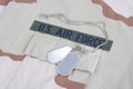 US AIR FORCE branch tape with dog tags on desert camouflage uniform Royalty Free Stock Photo